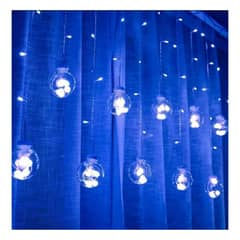 UNIVERSAL - CASCADA NAVIDAD PELOTAS TRANSPARENTES CON LUCES AZULES INTERIORES